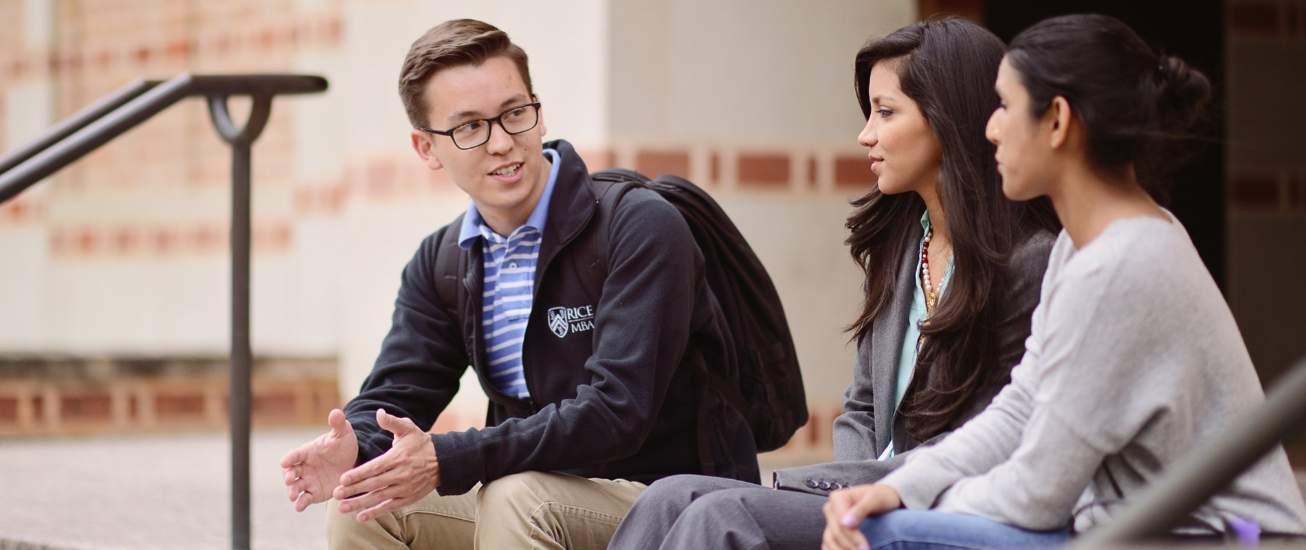 three_students_talking_outside_McNairHall_teaser