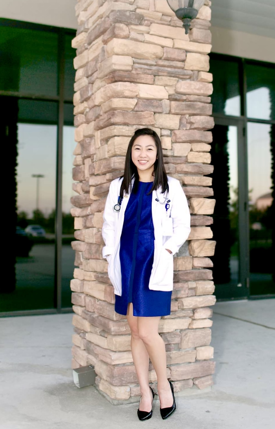 Sophie Lin, Rice MD MBA student wearing a white apron and stethoscope