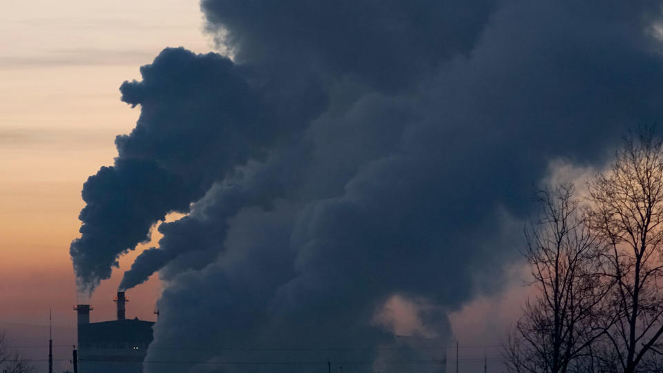 Smoke stack against a sunset