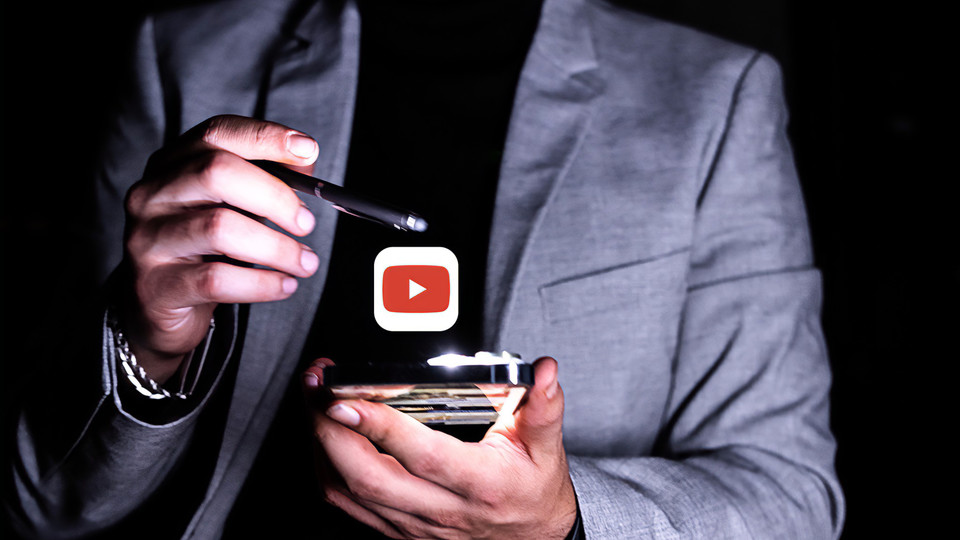 Man looking at YouTube video on phone