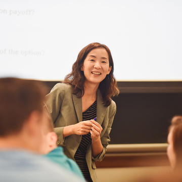 Female professor taking a question in class at Rice Business