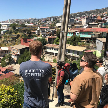 Student at GFE wearing a Houston Strong shirt looking at a view of a neighborhood in Brazil