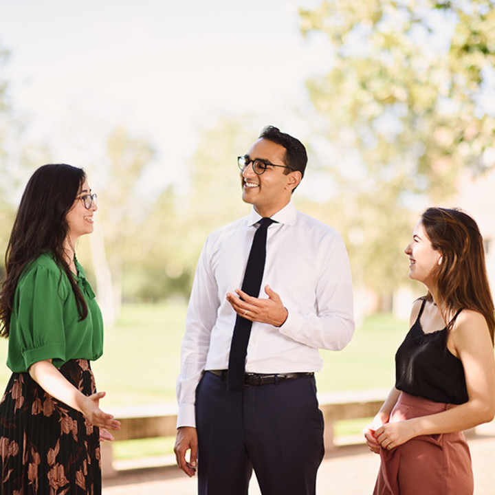 MAcc students discussing career benefits outside McNair Hall