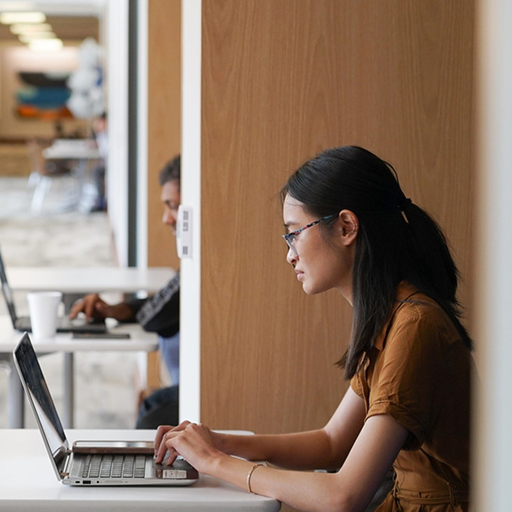 Rice Master of Accounting student working on her laptop